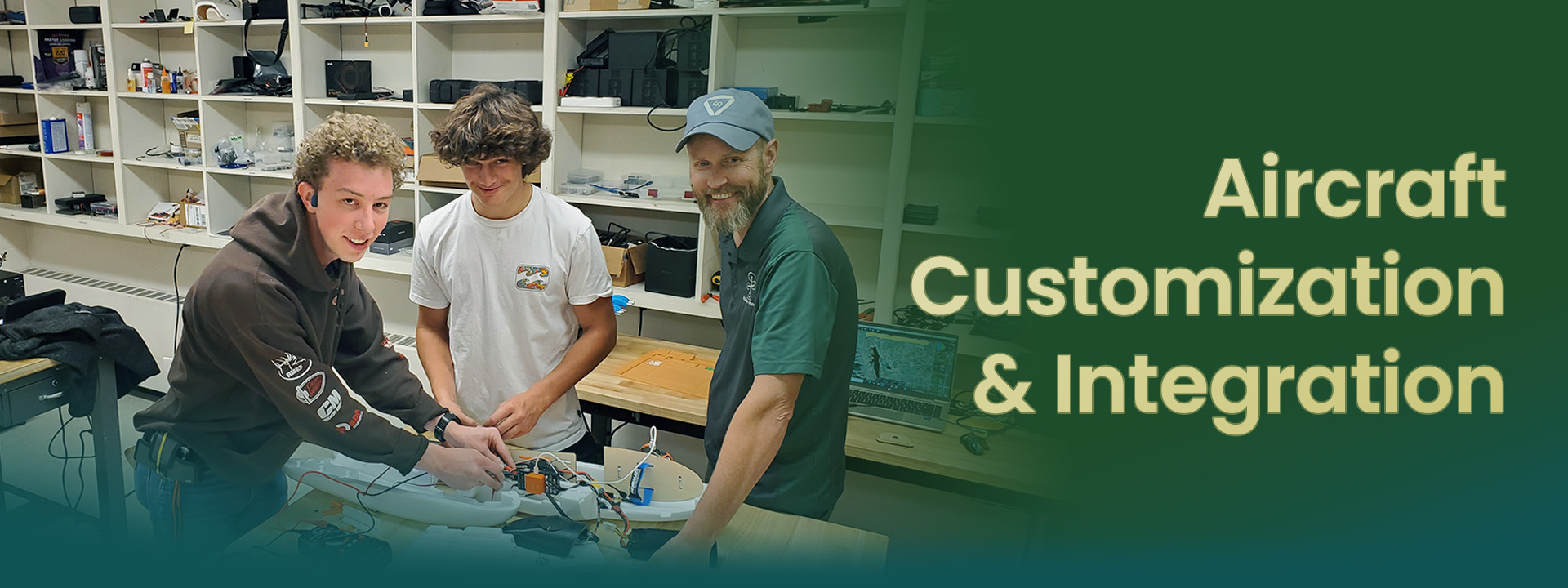 Three technicians collaborate on aircraft customization and integration in a workshop setting.