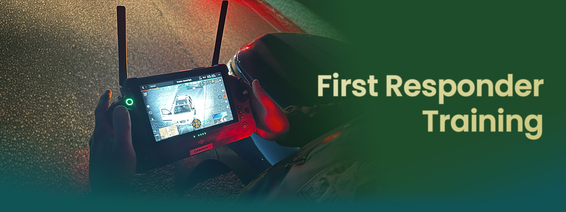 Person holding a remote monitor during first responder training at night.